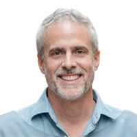 Studio headshot of smiling man with grey hair Boo Wicker for client feedback section